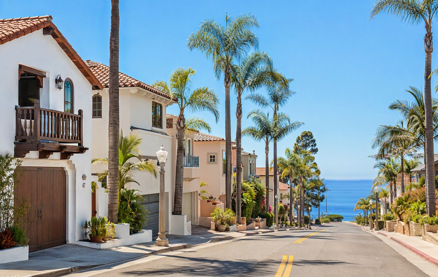 A sunny palm-lined street of coastal homes in Ventura, California